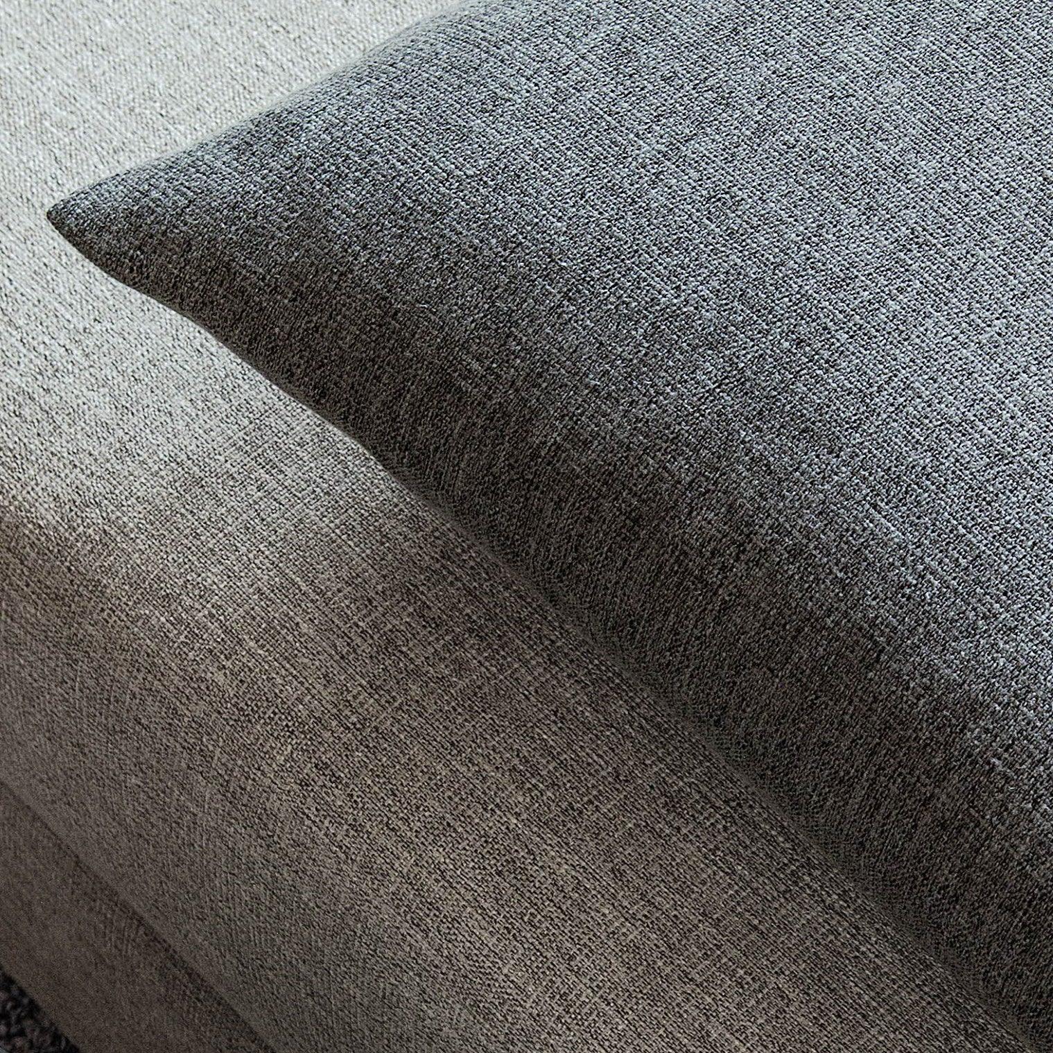 Joy linen fabric displayed on cushions.