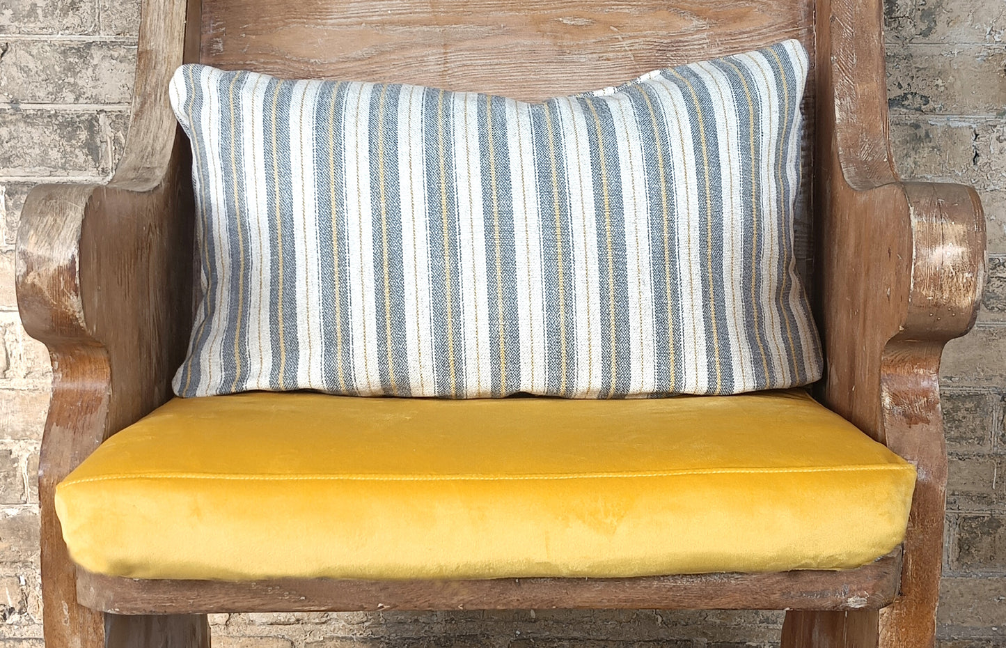 Blue and yellow striped cushions on bench