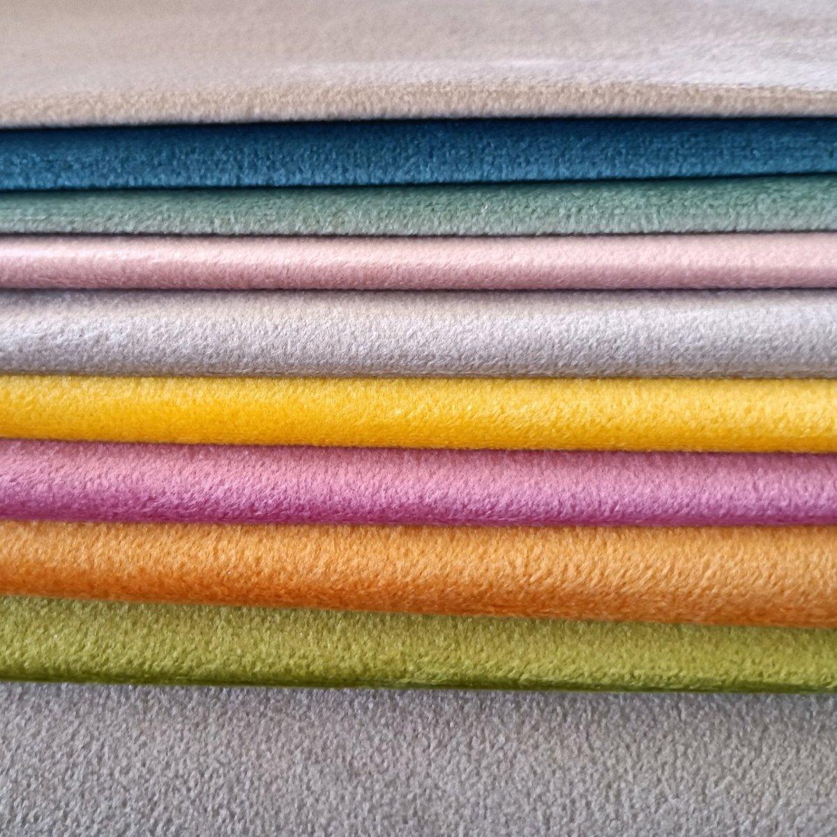 Stack of velvet samples for interior fabric design.