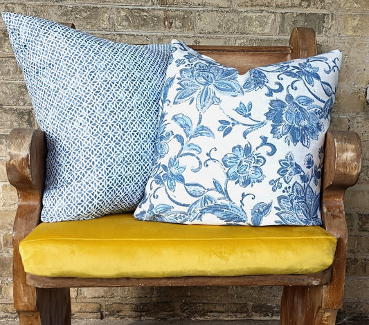 Blue and yellow cushions on bench