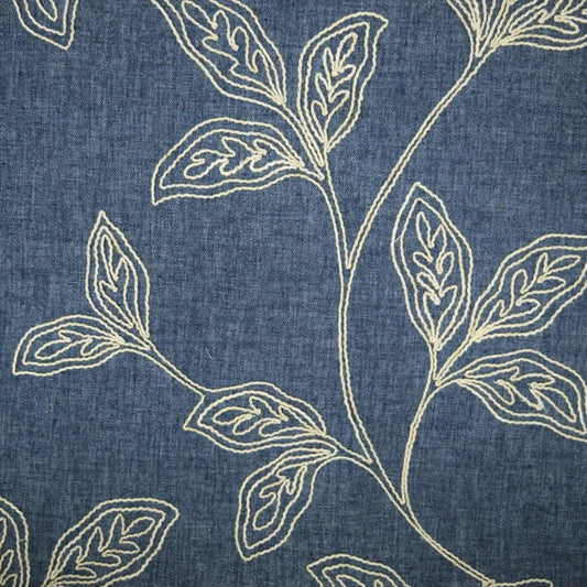 Linen curtain fabric with embroidered floral pattern.